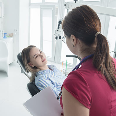 doctor talks to patient about how to reverse gum recession