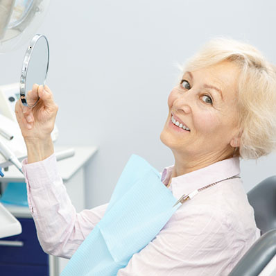 woman looking at dental implants