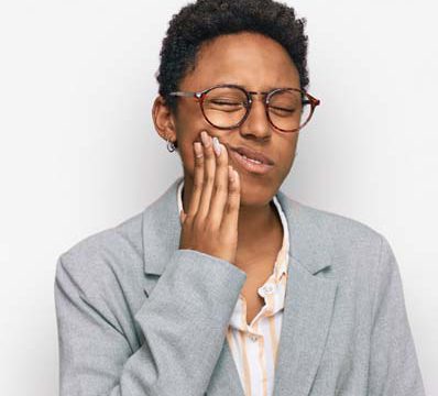 woman wincing in dental pain