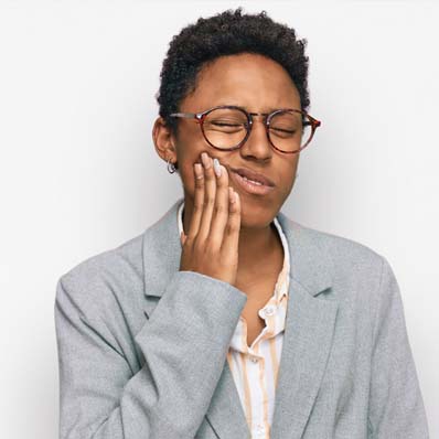 Coastal_BlogLP_398x398_Antibiotic (2) woman wincing in dental pain